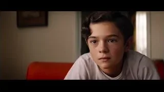 young boy sitting on red couch — Ford v Ferrari