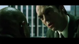 Man in suit shouting at camera — The Matrix