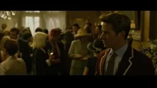 Man in suit holding wine at ornate bar — The Social Network