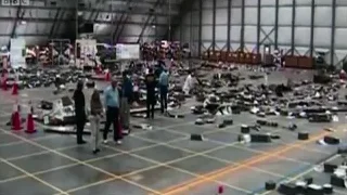 People in large hall with debris — Elon Musk: Return to Space