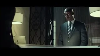 man in suit standing by desk — John Wick
