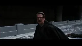 man walking on snowy street at night — Batman: The Dark Knight Rises