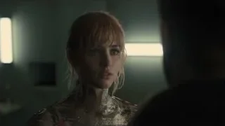 young woman in metallic dress in dimly lit room — Blade Runner 2049
