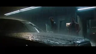 two men in a dimly lit garage with a car — Fight Club