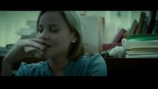 young woman deep in thought at desk — Limitless