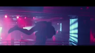DJ performing on stage with lights — John Wick