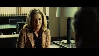 woman in patterned blazer in dimly lit room — Limitless