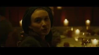 Young woman at candlelit table — The Social Network