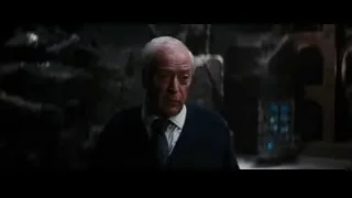 elderly man deep in thought in dark room — Batman: The Dark Knight Rises