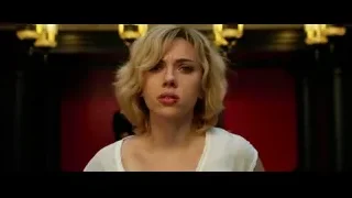 Woman in dimly lit room with red walls — Lucy
