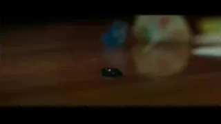 Small black object on wooden surface — Spiderman: No Way Home