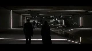 man and woman with futuristic robot — Batman: The Dark Knight Rises