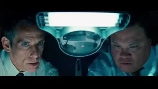 two men looking at magnifying glass in dark room — The Secret Life of Walter Mitty
