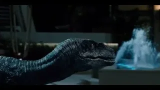 people in dimly lit room with T-Rex — Jurassic World