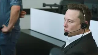 man in suit with headset in call center — Elon Musk: Return to Space