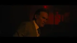 Man in suit in red lit room — Furious Seven