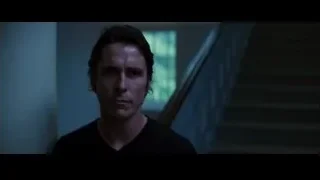 Man looking serious in dimly lit room — Batman: The Dark Knight Rises