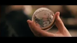 Hand holding glass ball with red flower — Harry Potter and the Philosophers Stone