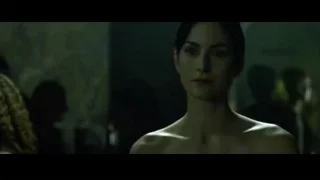 Woman in black dress in dimly lit room — The Matrix
