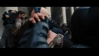Bane holding gun with police in background — Batman: The Dark Knight Rises