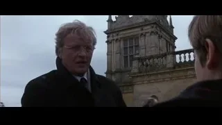 man by old building with clock tower — Batman
