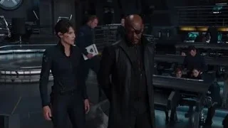 Man and woman with serious expressions in futuristic room — The Avengers