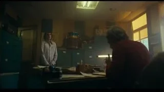 Man standing in room with blue lockers — Joker