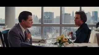 two men in suits at restaurant table — The Wolf Of Wall Street
