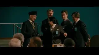 five men in room with medal and green wall — The Dictator