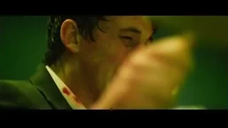 man's bloody face in green light — Whiplash