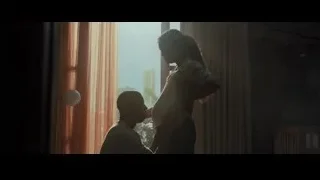 Young woman at table in dim room — Creed 2