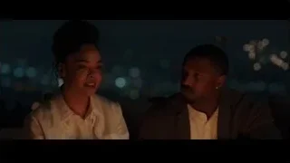 young couple sitting on bench at night — Creed 3