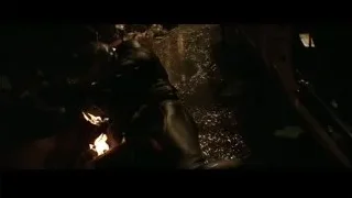 people gathered around fire in dark room — Batman