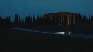 car driving past large mansion at night — Succession