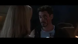 bloody man talking to woman by fire — Iron Man 3