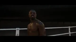 Shirtless man in boxing ring with serious expression — Creed 3