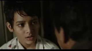 Young boy's serious face in collared shirt — Life of Pi