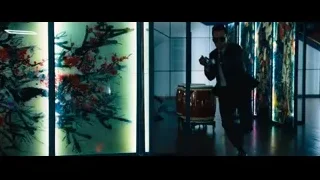 man in suit holding sword in art room — John Wick: Chapter 4