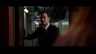 Man in suit leaning on door in hallway — Steve Jobs