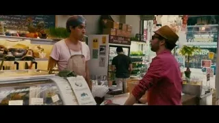 two men standing at store counter — The Dictator