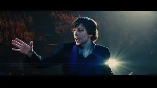 Man in suit speaking on stage — Now You See Me