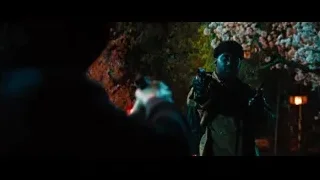 man with gun looking at flashlight in park — John Wick: Chapter 4