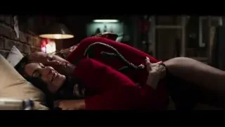 Man and woman in red pajamas on bed — Deadpool