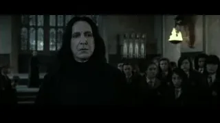 Man in black robe with boys in church — Harry Potter and the Deathly Hallows 2