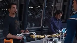 three men with robotic arms in futuristic room — The Avengers