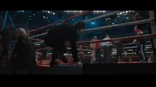 referee holding microphone in boxing ring — Creed 2