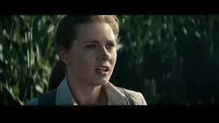 young woman standing in field with serious expression — Superman: Man of Steel