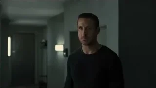 man in black sweater in dimly lit hallway — Blade Runner 2049