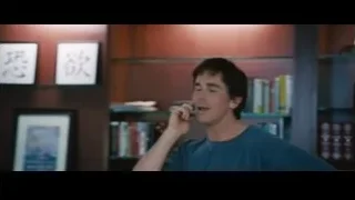 man in blue t-shirt talking on phone — The Big Short