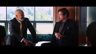 two bald men talking in room with windows — Iron Man